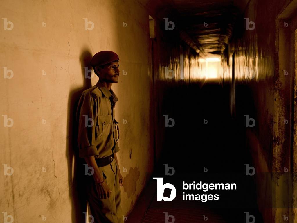 Soldier leaning against Wall in Hallway, Amber Fort, Jaipur, India (photo)