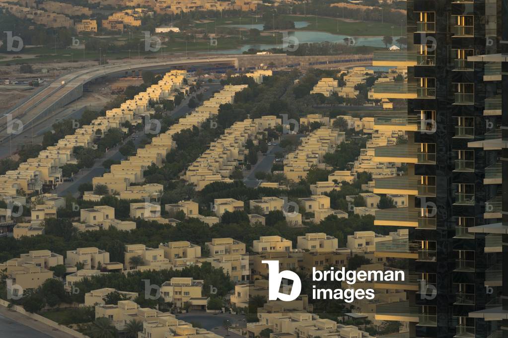 Residential tower with houses behind, Dubai, United Arab Emirates (photo)