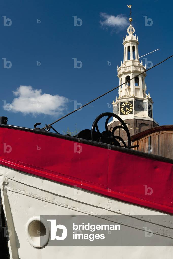 Holland, Bow of traditional Dutch barge with gabled houses in background, Amsterdam (photo)