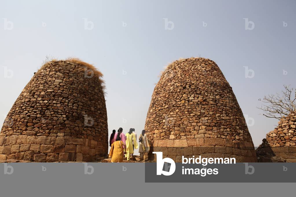 Tourists at domed stone structures, Badami, Karnatak, India (photo)