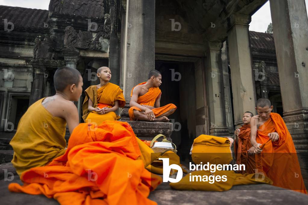 A group of young monks hanging out at Angkor Wat, Siem Reap, Cambodia (photo)