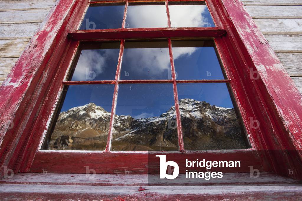 A reflection of mountains in an old mine building at Independence Mine in Hatcher Pass near Palmer, Southcentral Alaska, USA (photo)