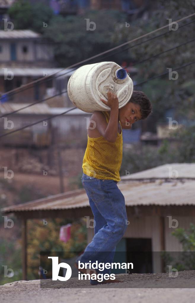 Boy carrying Container on Shoulders (photo)