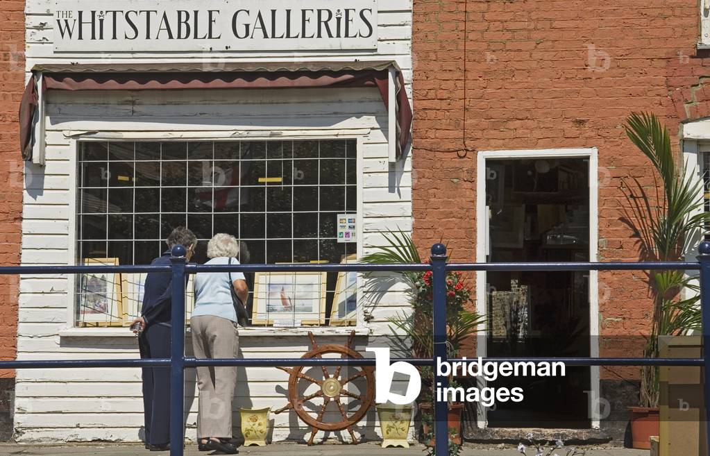 Two Women Looking Into A Gallery in Whitstable, Kent, England, UK (photo)