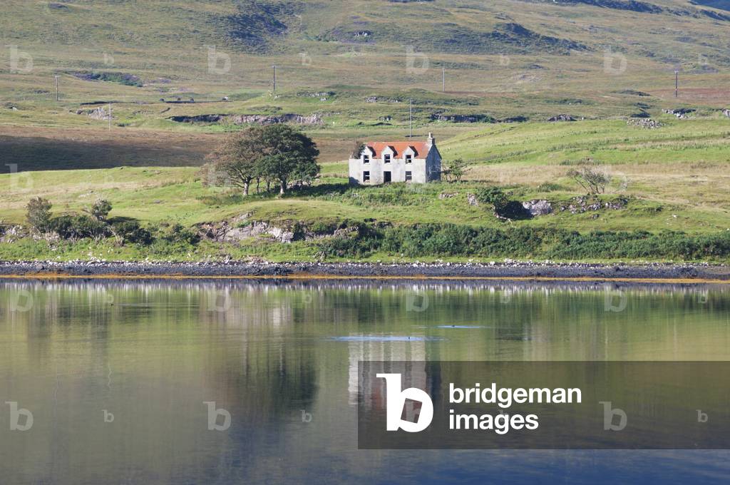 A lone house along the shoreline of the water, Skye, Scotland (photo)