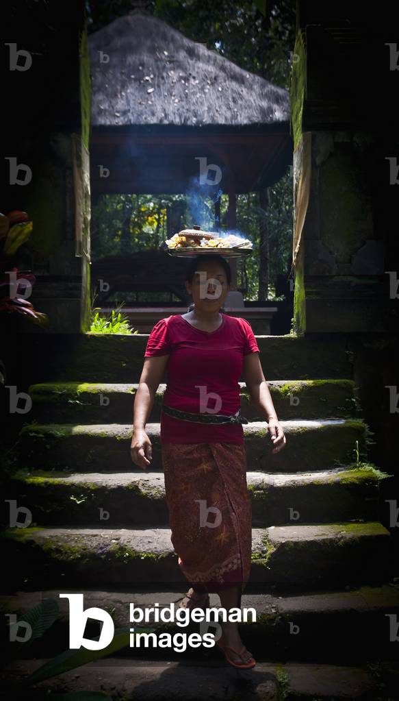 Woman Carrying Plate with Hot Food on Head, Ubud, Bali, Indonesia (photo)