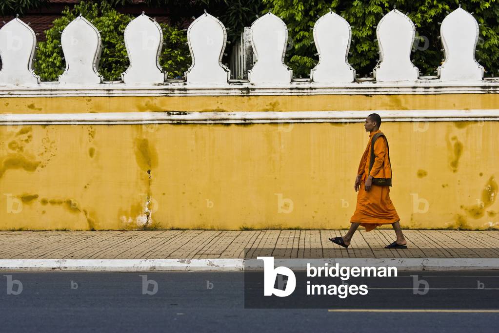 A Buddhist Monk Walks by the Front of the Royal Palace, Phnom Penh Cambodia (photo)