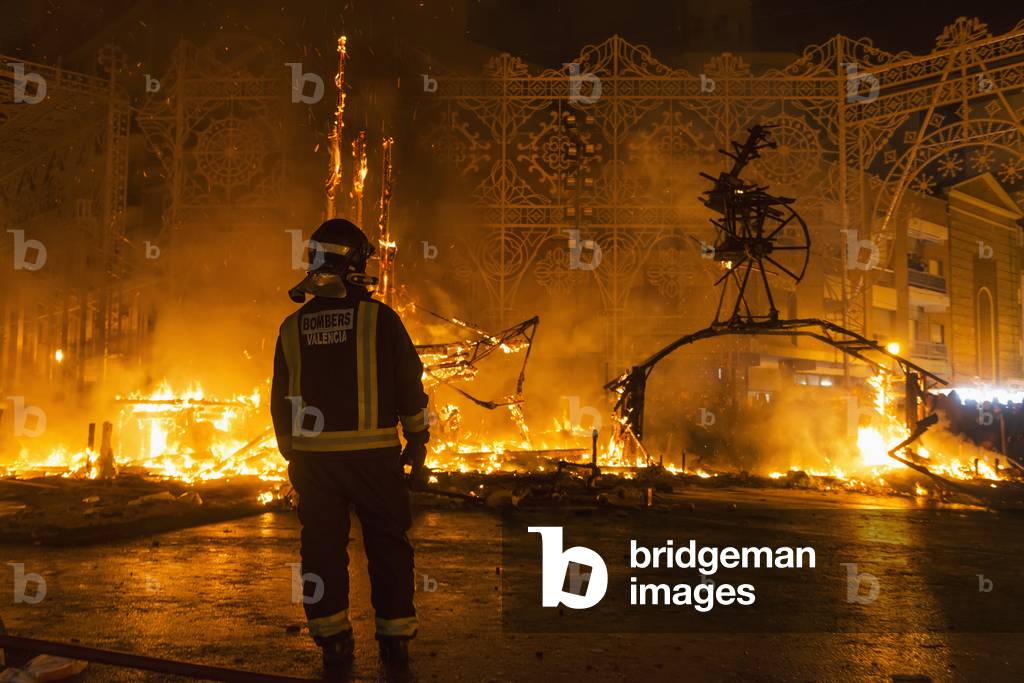 Fireman Watching Burning Falla on Fallas Festival, Valencia, Spain (photo)