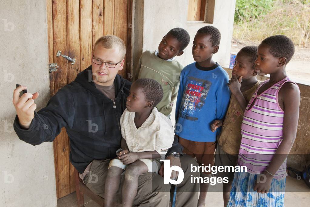 A Young Man Showing Something to a Group of Young Boys, Manica, Mozambique, Africa (photo)