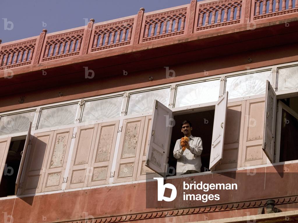 Man Standing At Window, Holding Flower Garland, Jaipur, Rajasthan, India (photo)