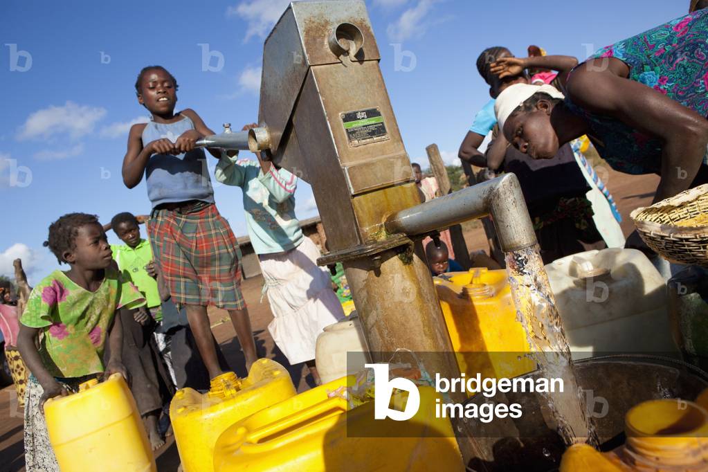 A Young Girl Pumps Clean Water from the Well, Manica, Mozambique, Africa (photo)