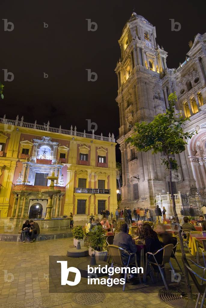 People at Cafe Tables in Square in Front of Cathedral  and Palacio Episcopal at Night, Malaga, Andalucia, Spain (photo)