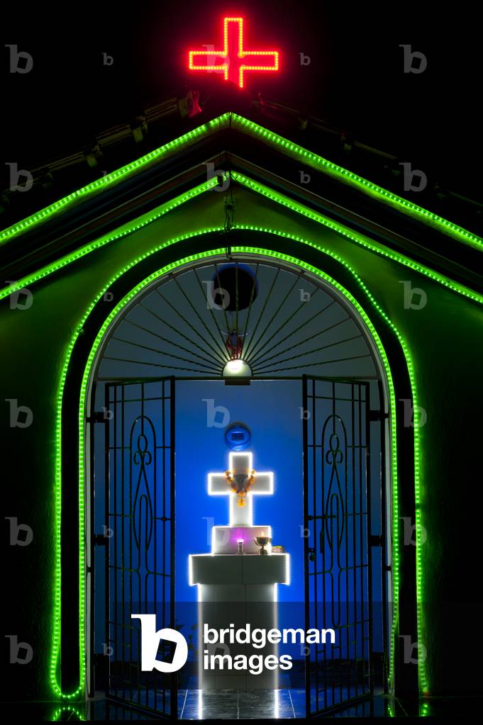 Colourfully lit chapel at night, Goa, India (photo)