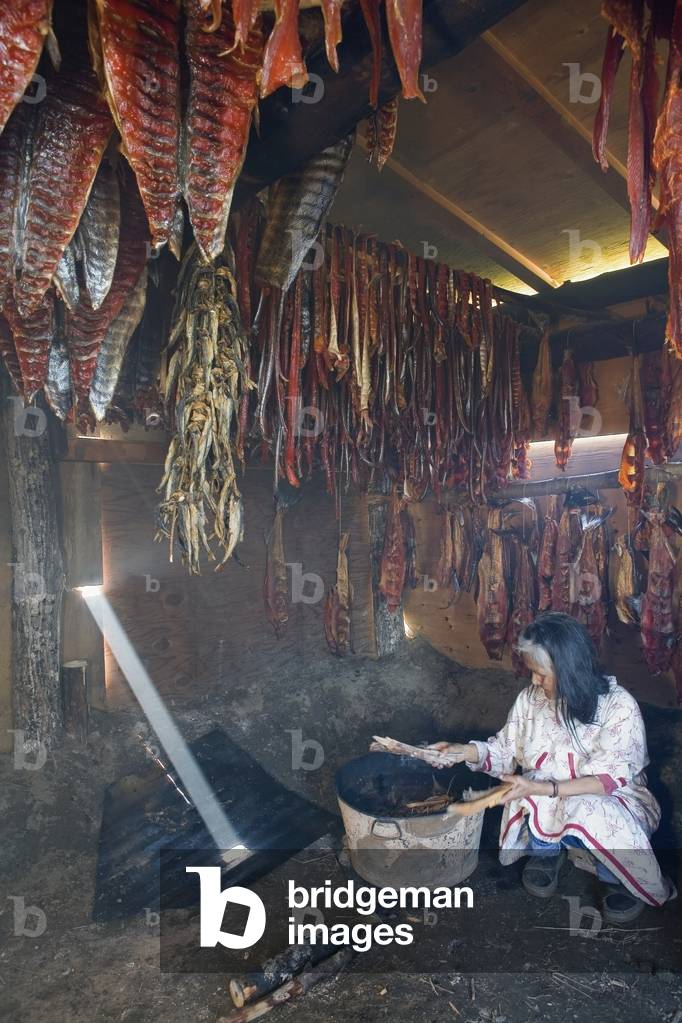 Elder Native Yupik Woman Inside Smokehouse Checks Hanging Salmon Agiachak Western Alaska Summer (photo)