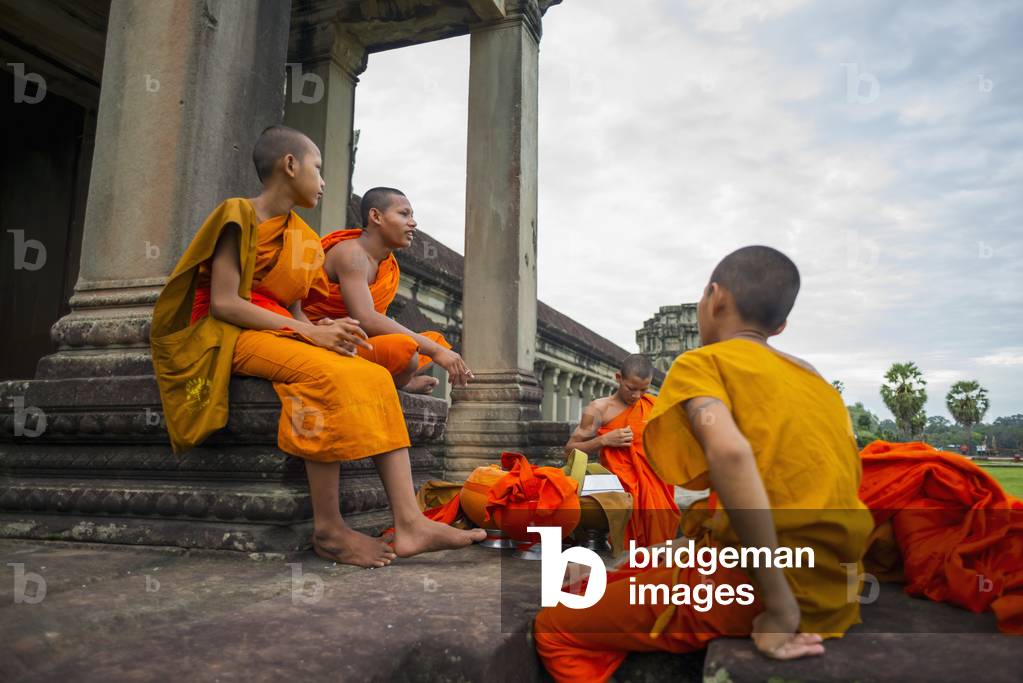 A group of young monks hanging out at Angkor Wat, Siem Reap, Cambodia (photo)