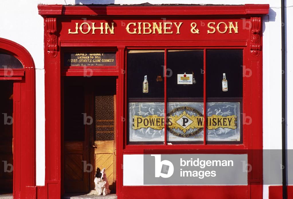 John Gibney & Son, Skerries, Co Dublin, Ireland; Dog Sitting Outside A Pub (photo)
