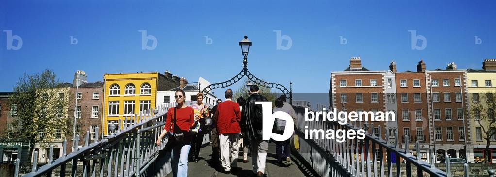 Tourists Walking On A Bridge, Ha'penny Bridge, Dublin, Republic Of Ireland (photo)