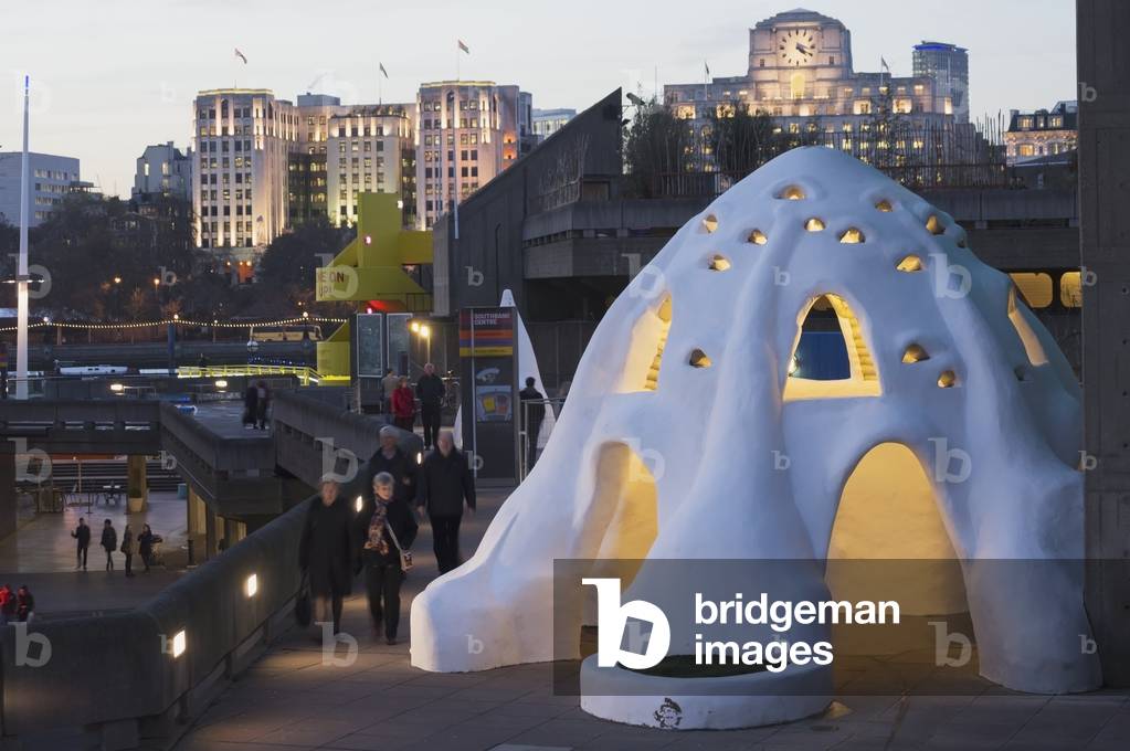 An igloo sculpture and building illuminated at dusk, London, England, UK  (photo)
