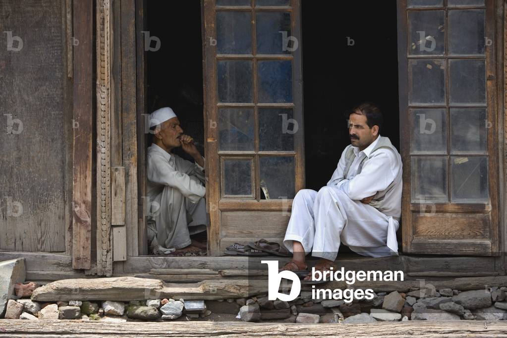 Two Men sitting in Doorway, Srinagar, Kashmir, India (photo)