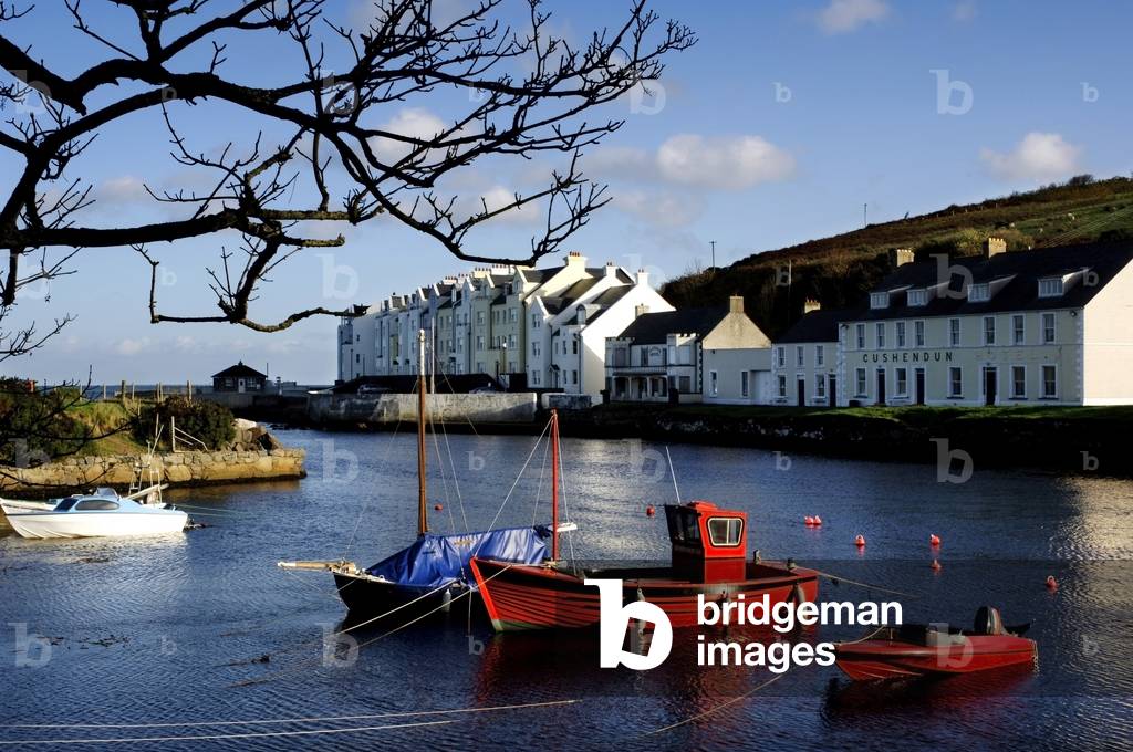 Boats Moored At A Riverbank With Buildings In The Background, Cushendun, County Antrim, Northern Ireland (photo)