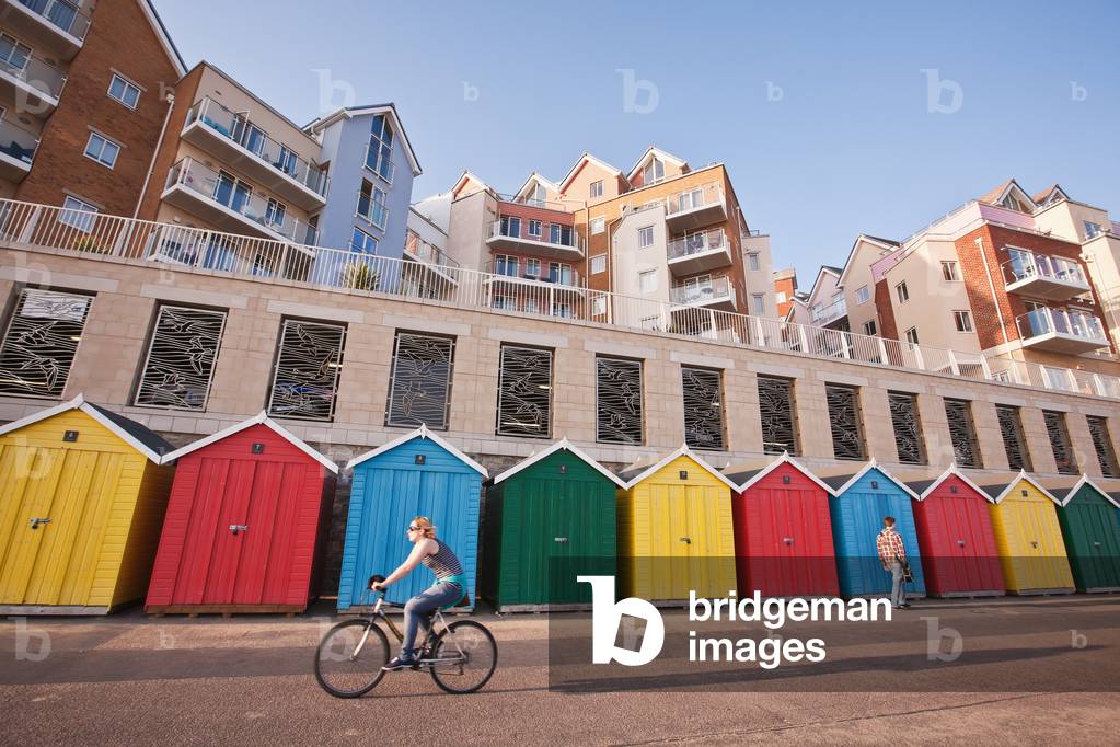 Cyclist, Pedestrian, Colorful Beach Huts and Apartments at Honeycombe Beach Development Next To Boscombe Pier, Bournemouth, Dorset, England, UK  (photo)