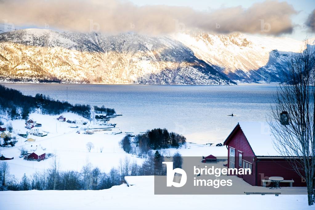 View of the village, Fjord and mountains with the sun setting over the mountains, Ortnevik, Sognefjord, Norway (photo)