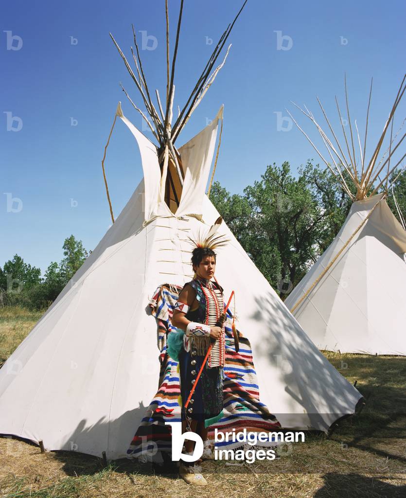 Crow Teenager in front of his Tepee, Montana, USA (photo)