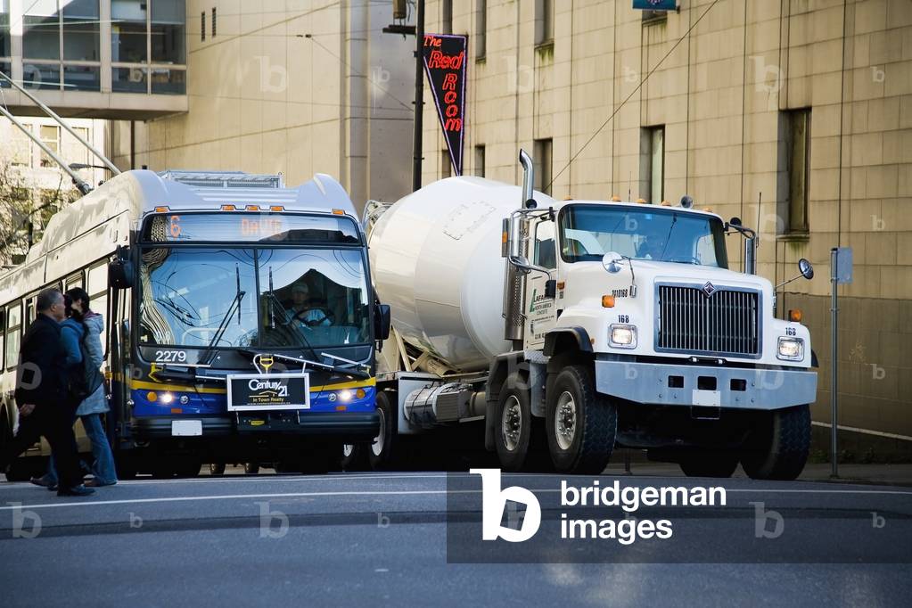 Cement Mixer Truck and Trolley Bus Waiting To Pass at Junction, Vancouver, British Columbia, Canada (photo)