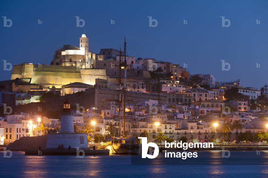 Spain, Looking across harbor to Ibiza town at dusk, Ibiza (photo)