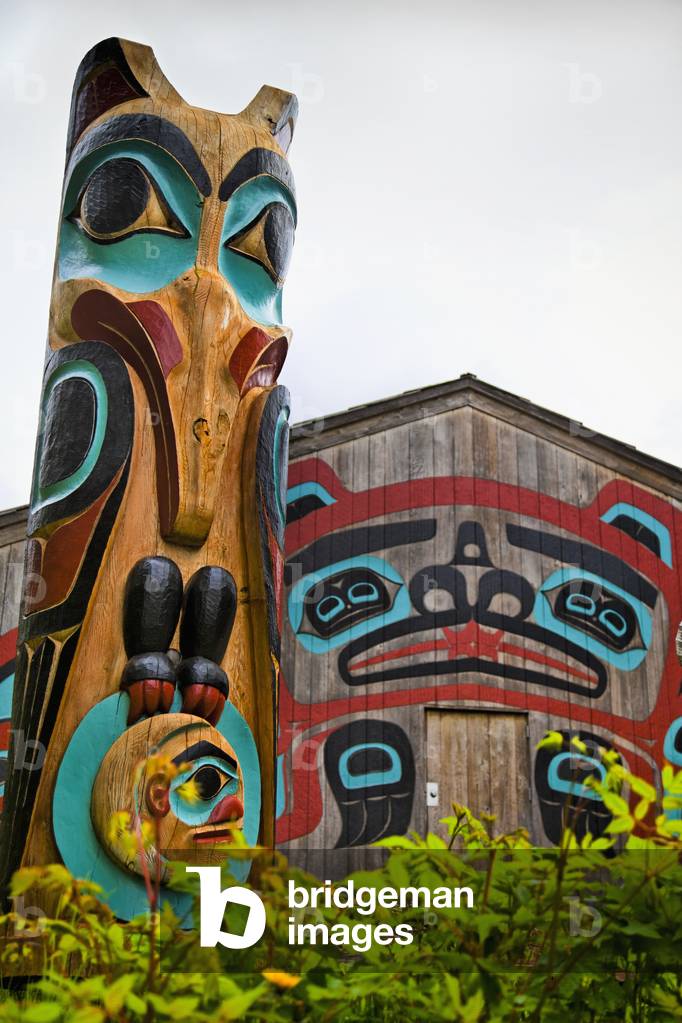 Close Up Of Raven Totem Pole And Beaver House At Saxman Totem Park, Ketchikan, Southeast Alaska, Summer (photo)