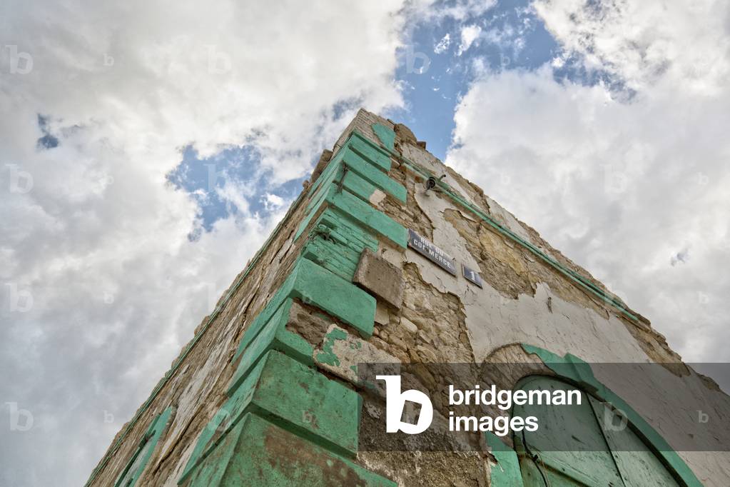 Low Angle View of the Corner of a Building with a Cloudy Sky Overhead, Jacmel, Haiti (photo)