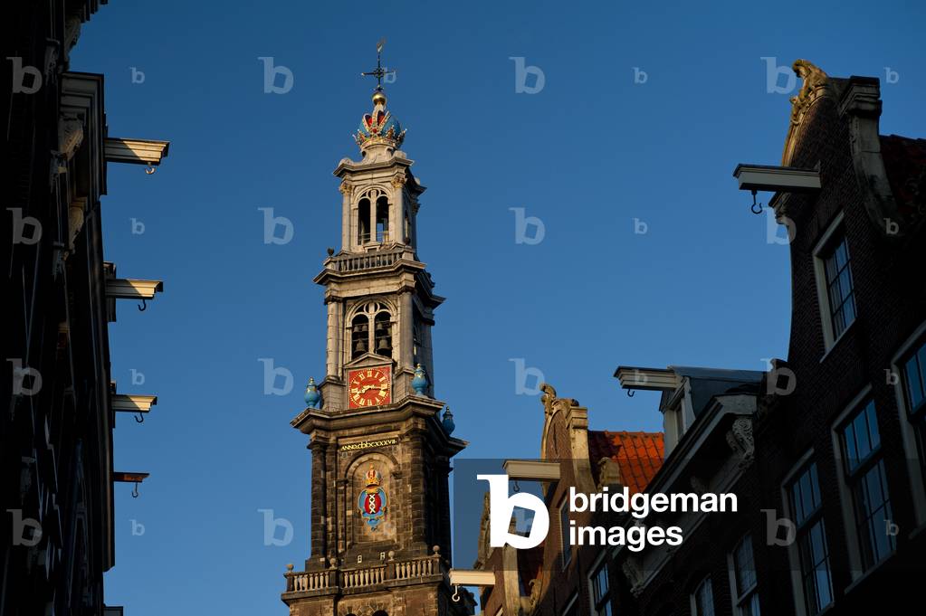 View along street of gabled houses to Oude Lutherse Kerk (church) at dusk, Amsterdam, Holland (photo)