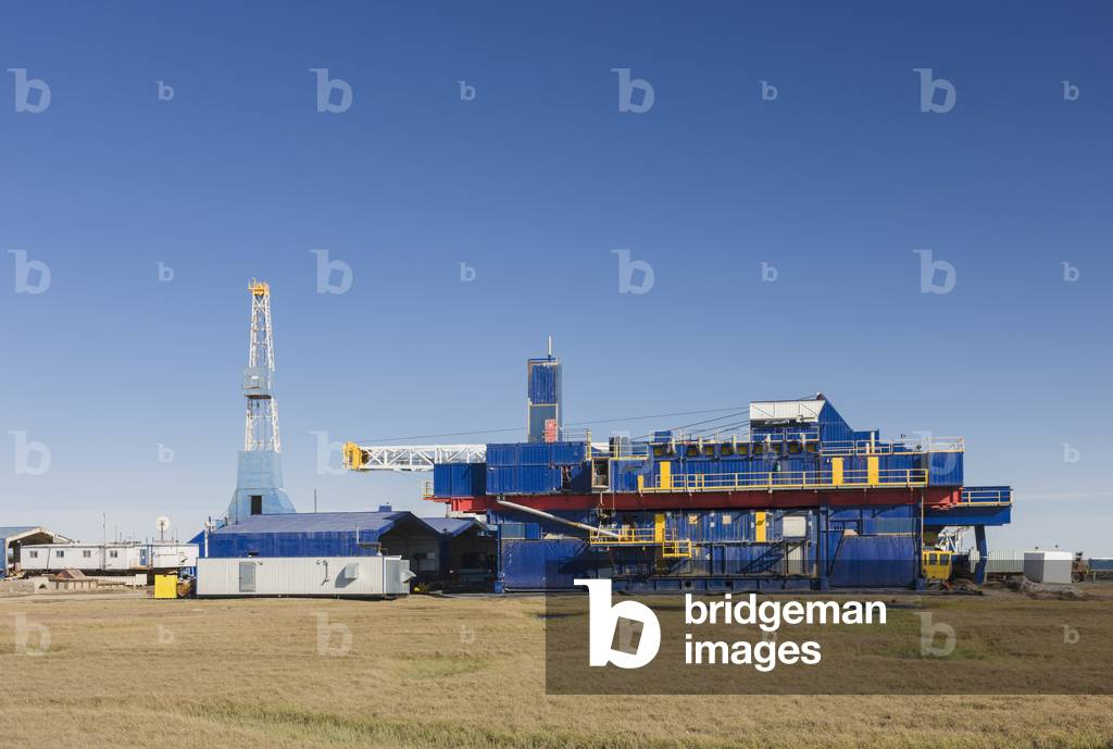 Oil and gas drill rig with surrounding infrastructure, Prudhoe Bay, Arctic Alaska, USA, Summer (photo)