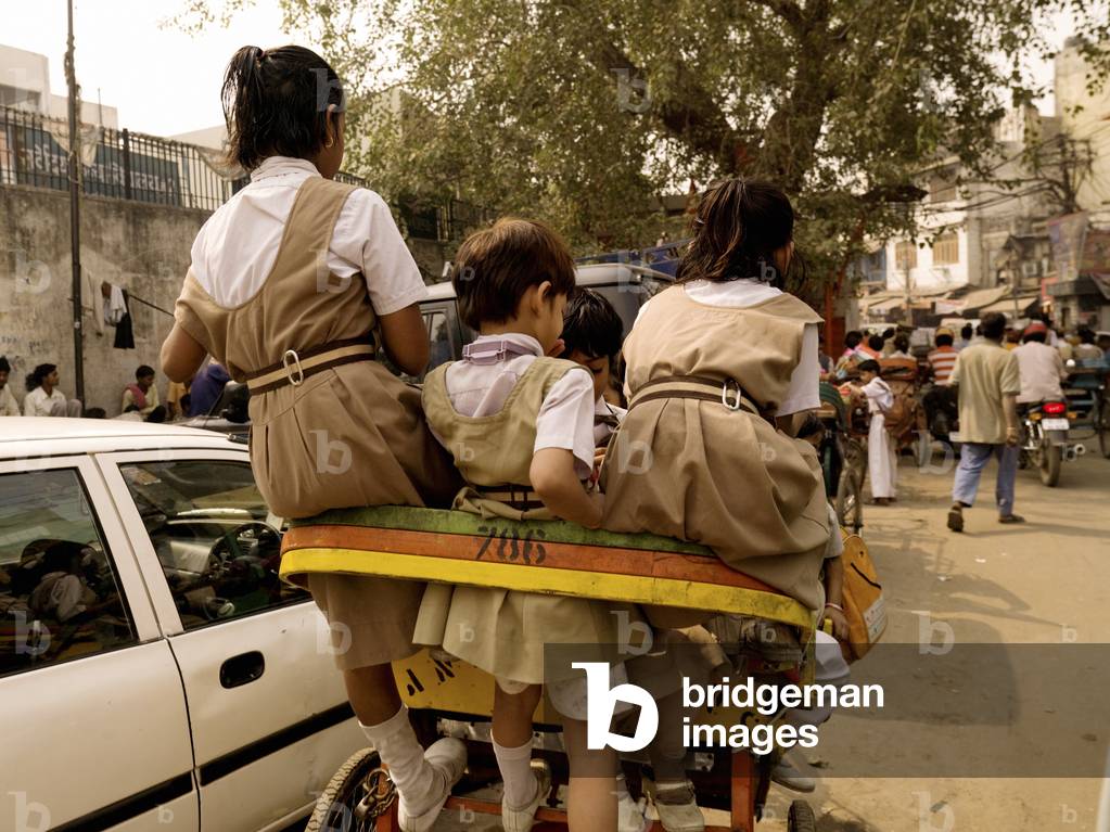 Schoolgirls Hitching a Ride on a Rickshaw, on a Busy City Street, Delhi, India (photo)
