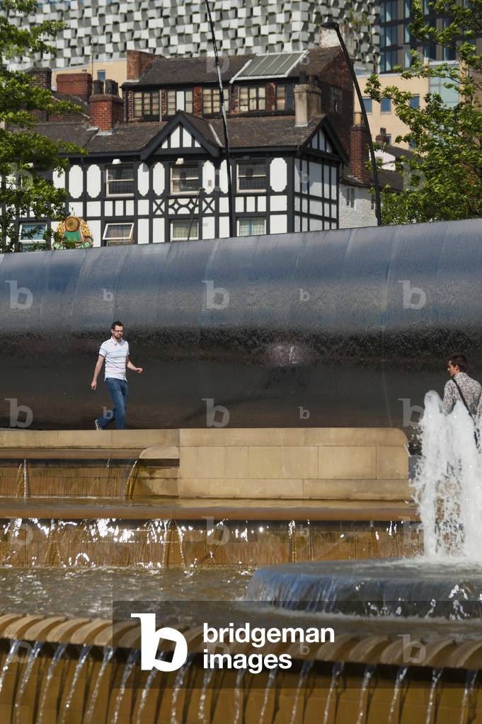 UK, South Yorkshire, Man walking near fountain, Sheffield (photo)