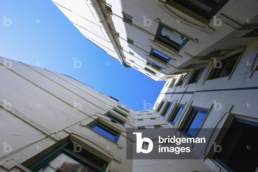 Low angle view of a white building with windows and walls on five sides and a blue sky, Hamburg, Germany (photo)