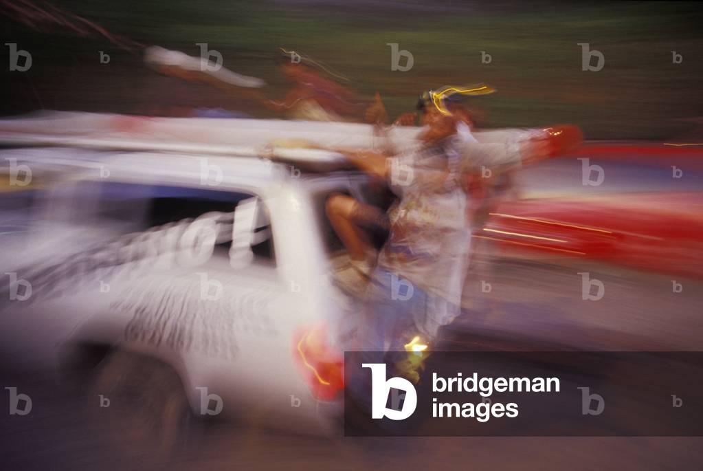 People hanging from Vehicle (photo)