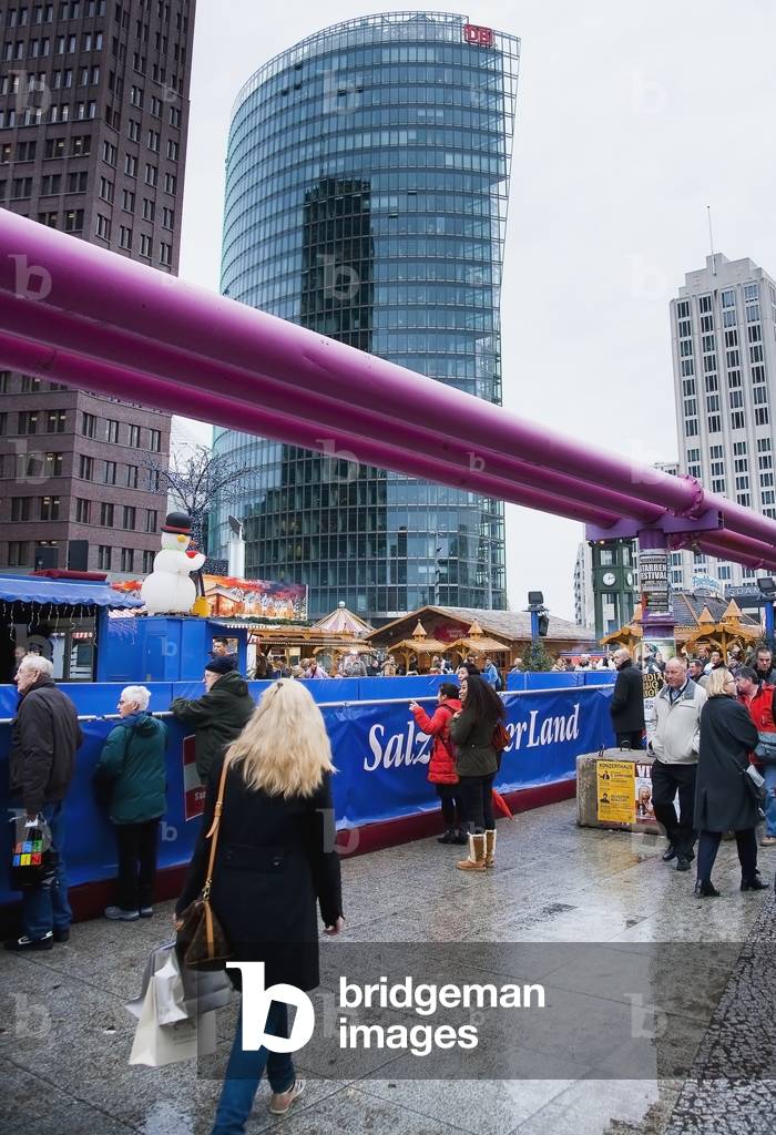 Germany, Berlin, Giant purple utility pipes go overhead Christmas Market, Potsdamer Platz Berlin (photo)