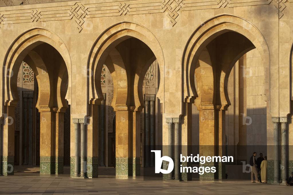 Morocco, Men chatting beside Hassan II mosque, Casablanca (photo)