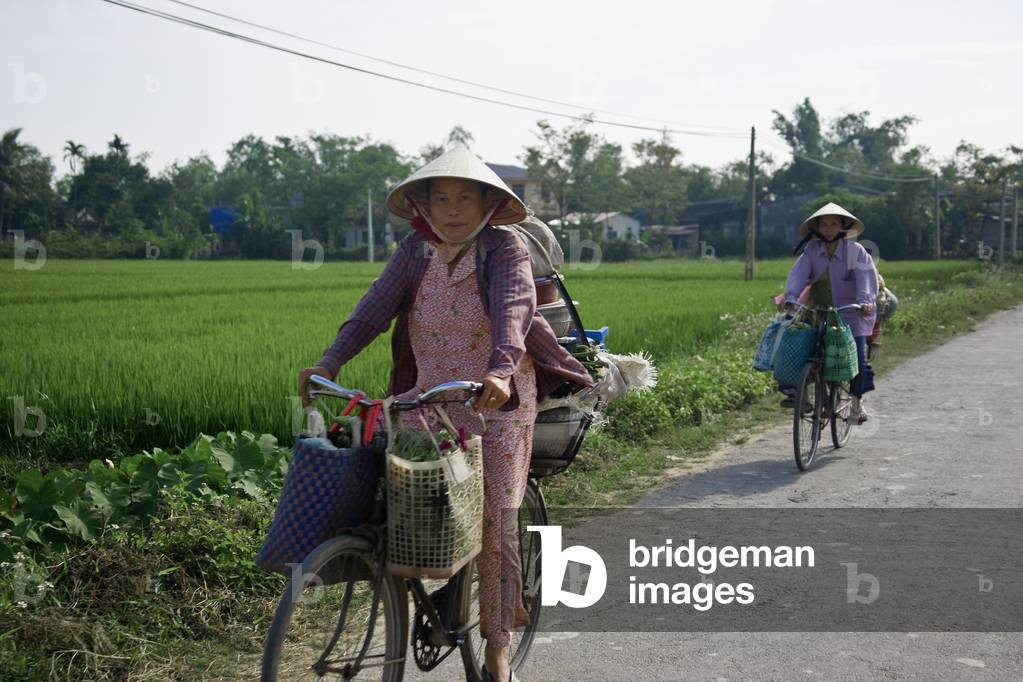 Two Women Riding Bicycles, Quang Nam, Vietnam (photo)