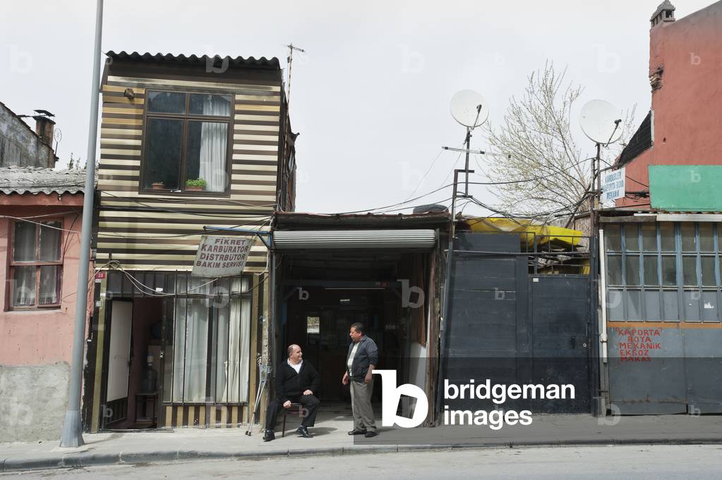Two men talking outside old houses, Istanbul, Turkey (photo)