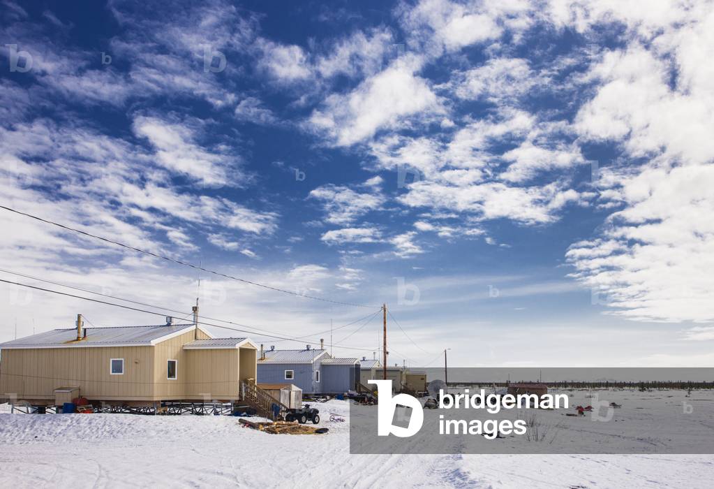 New housing units and power lines along a snow-covered street in Noatak, Arctic Alaska, USA, Winter (photo)