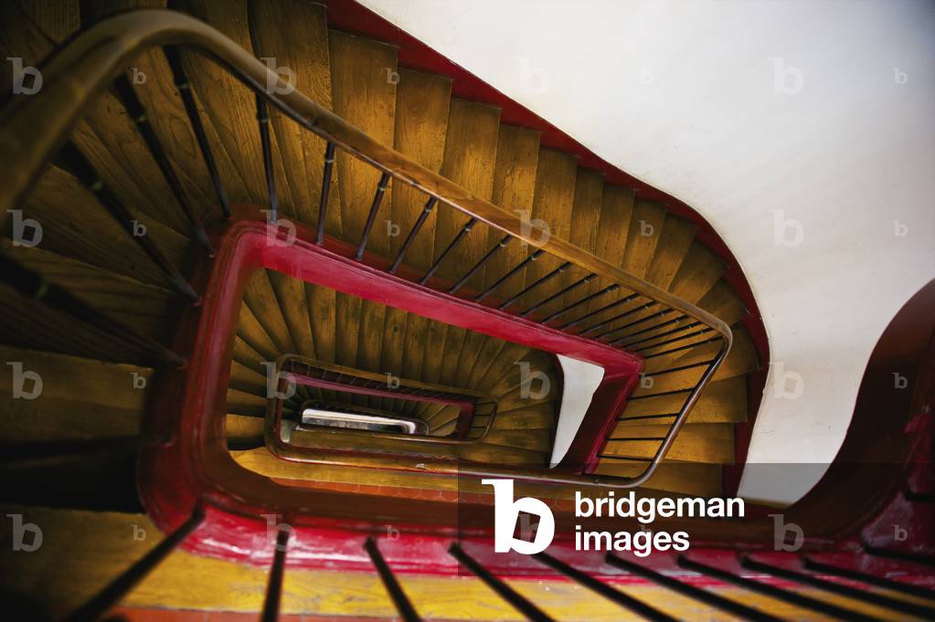 High angle view of a wooden steps, handrail and railing inside a building, Marais district, Paris, France (photo)