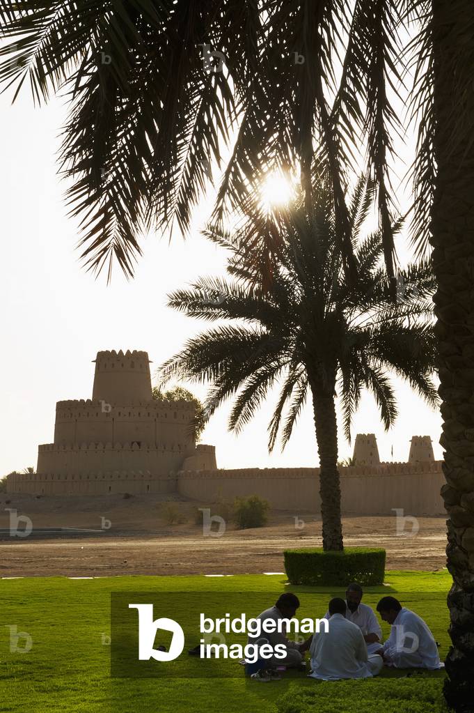 Men Playing Cards in Front of Al Jahili Fort, Al Ain, Abu Dhabi, United Arab Emirates (photo)