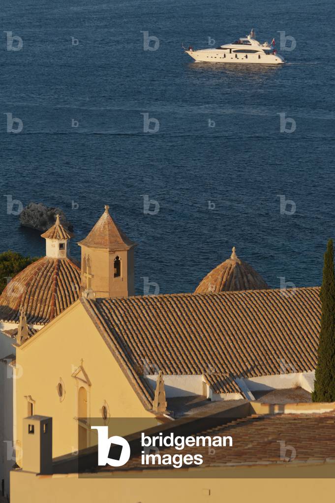 Spain, Ibiza, Looking over shaded roof terrace and Santo Domingo church in Dalt Vila, Ibiza Town (photo)