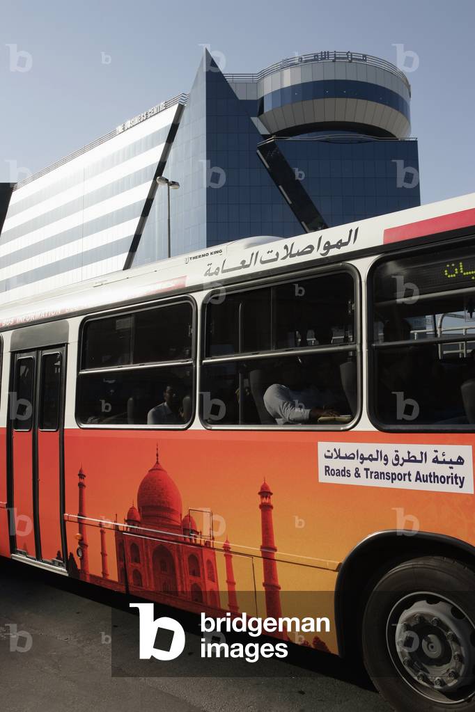 United Arab Emirates, Bus with Mosque Depicted on the Side in Front of Modern Building, Dubai (photo)