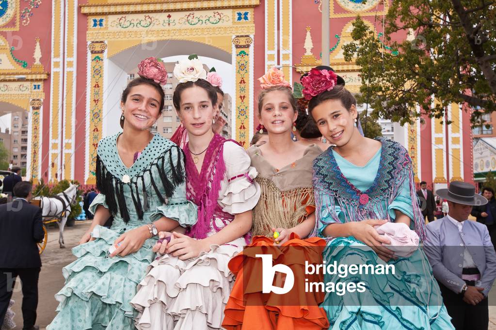 Portrait of Four Young Women Wearing Traditional Dresses During April Feria Festival, Seville, Andalucia, Spain (photo)