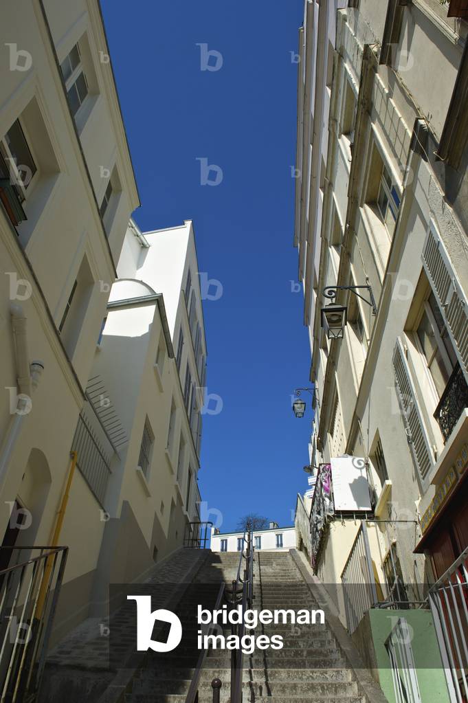 Steps leading up between residential buildings, Paris, France (photo)