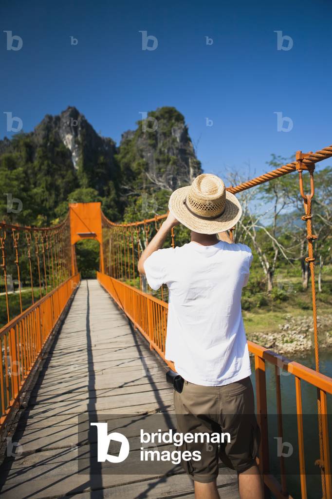 A bridge leads to caves outside of Vang Vieng, Laos (photo)