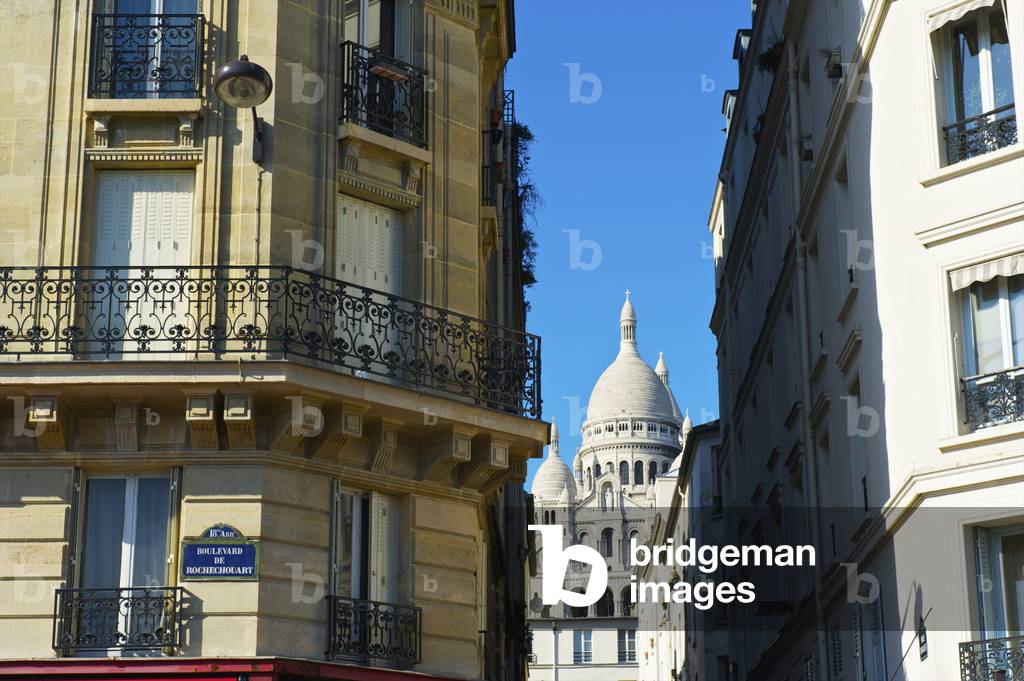 Residential buildings with the dome roof of the Basilica of the Sacred Heart of Paris viewed between the buildings, Paris, France (photo)